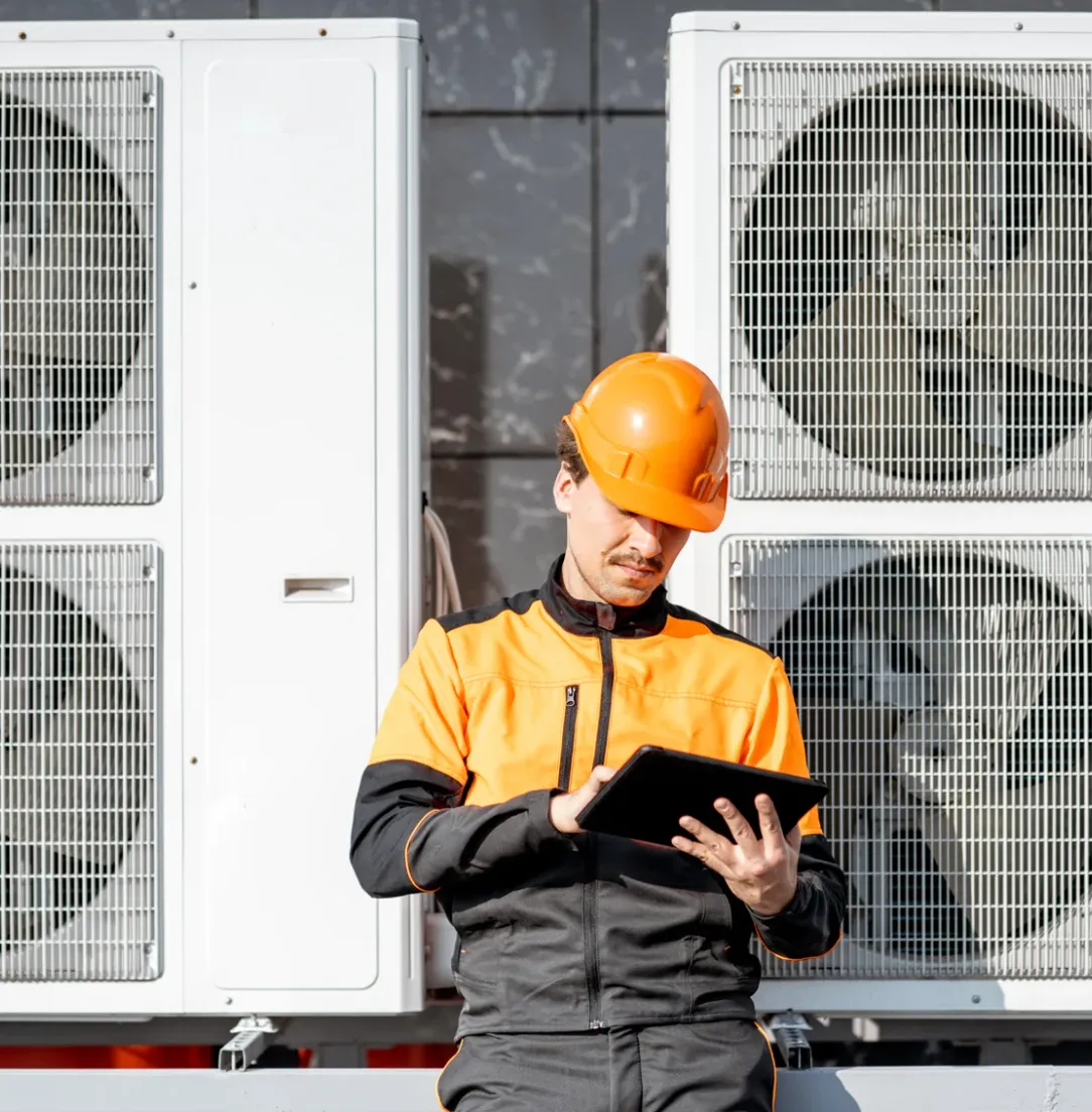 Crabbe technician inspecting HVAC systems with a tablet
