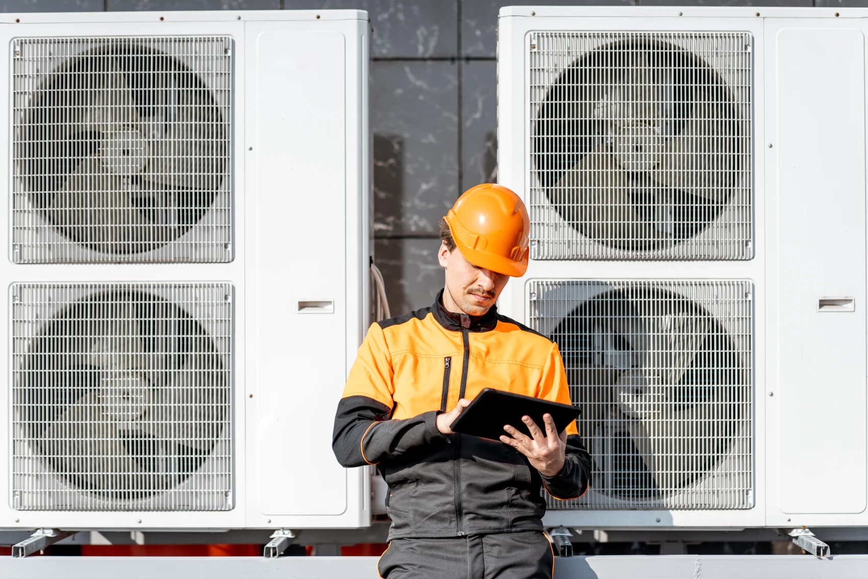Crabbe technician planning an HVAC system on a tablet